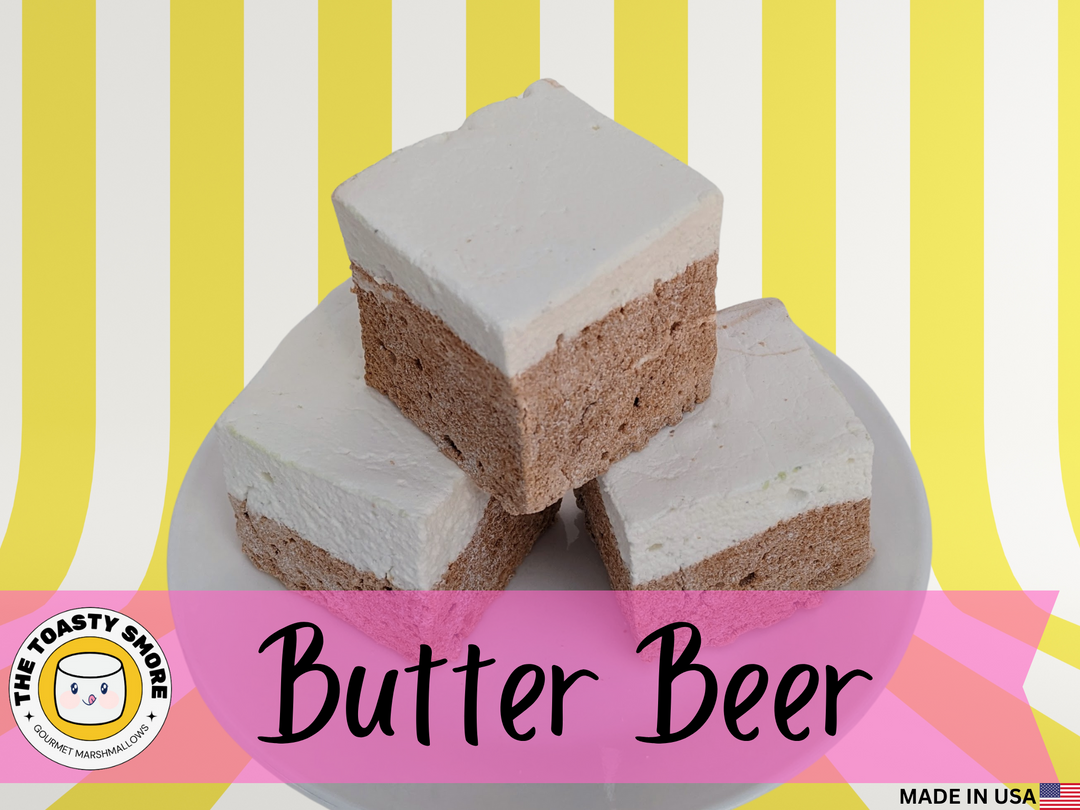 Three large Butterbeer marshmallows rest on a plate, their fluffy, golden cubes gleaming with a butterscotch shimmer. Handcrafted with premium beef gelatin and no corn syrup, these USA-made gourmet marshmallows are perfect for s’mores, snacking, or gifting.
