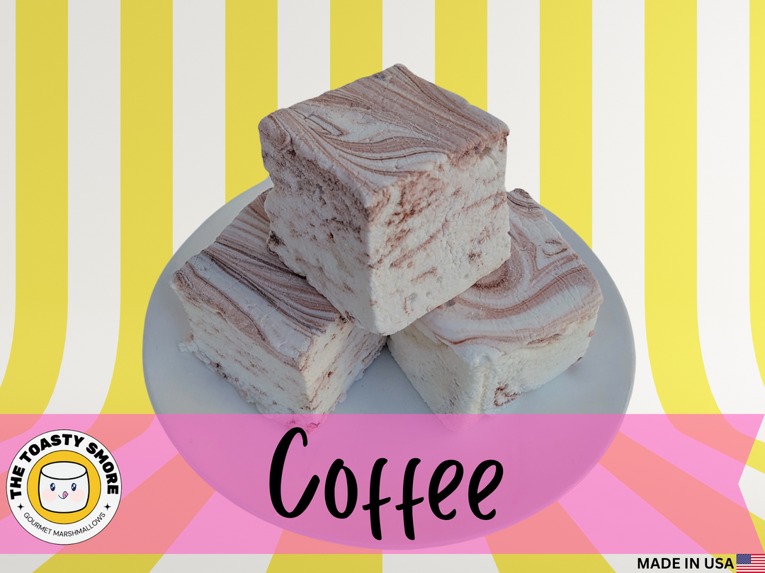 A close-up view of coffee-flavored gourmet marshmallows, handcrafted and made in the USA by The Toasty Smore, arranged on a white plate. Each marshmallow is white with delicate brown swirls, showcasing the rich coffee infusion. The soft, fluffy texture contrasts beautifully with the smooth, marbled design, highlighting their artisanal quality. Perfect for coffee lovers, these best gourmet marshmallows offer a bold yet sweet flavor, ideal for pairing with hot drinks or enjoying as a decadent treat.