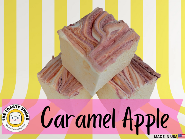 Jumbo marshmallows in a pale yellow base with bold red and orange caramel‑apple swirls, crafted with natural coloring, artificial flavoring, and organic marshmallow root.