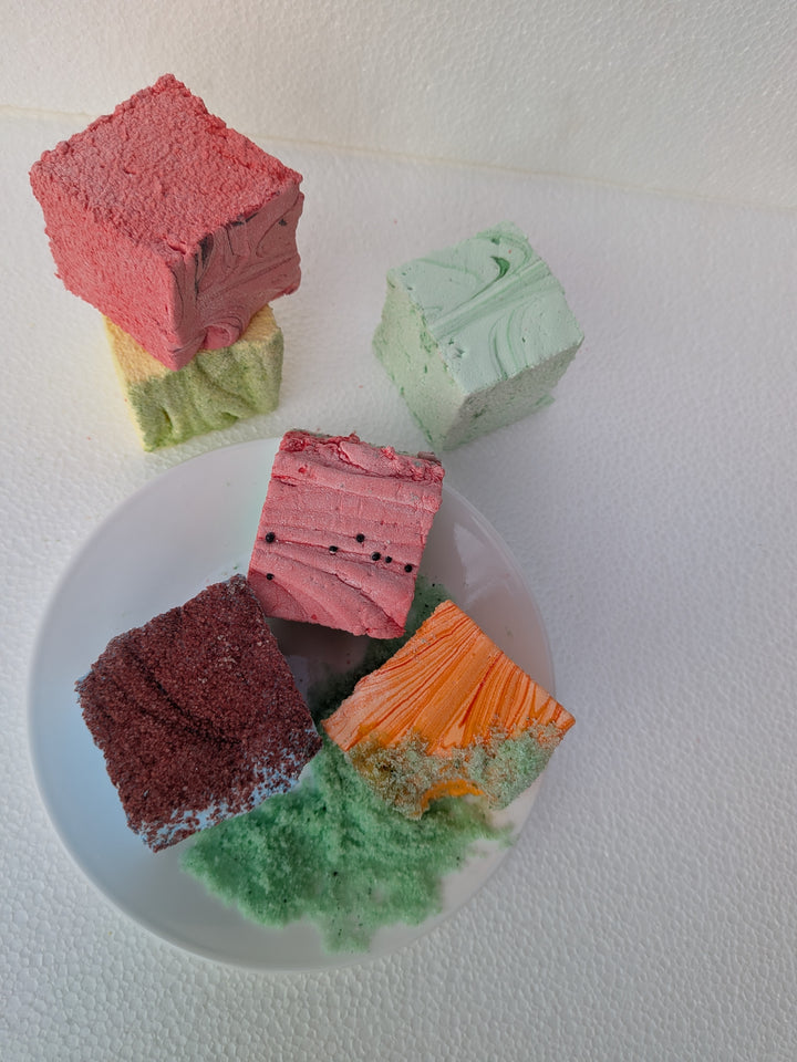 Colorful cake slices on a white plate with a white background