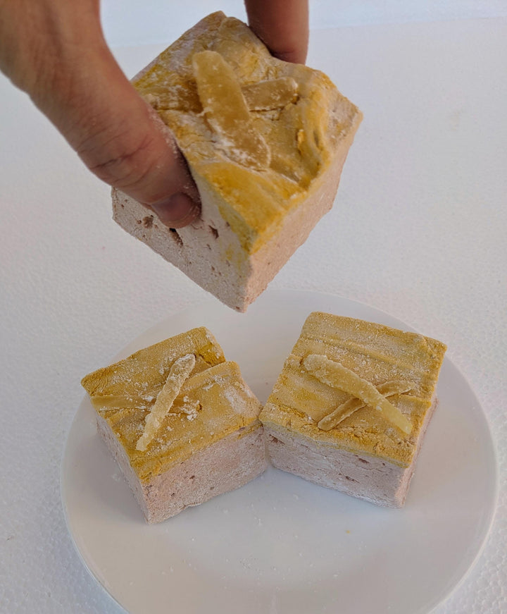 Hand Picking Up Handcrafted Gourmet Gingerbread Marshmallows – Trio on Plain White Background, Made in USA by The Toasty Smore