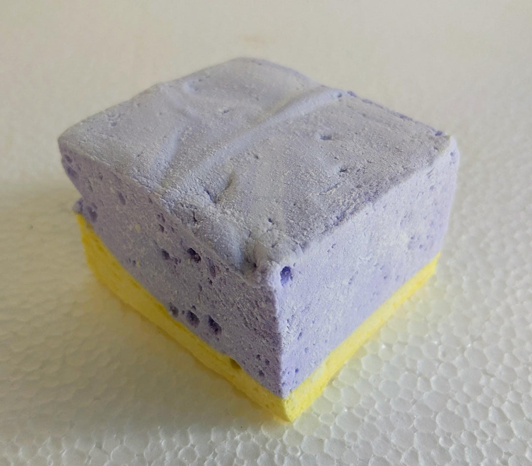A single handcrafted gourmet lavender & honey marshmallow displayed on a clean white background. The marshmallow is approximately 2" x 2" x 1.5", showcasing its soft, fluffy texture and delicate floral flavor