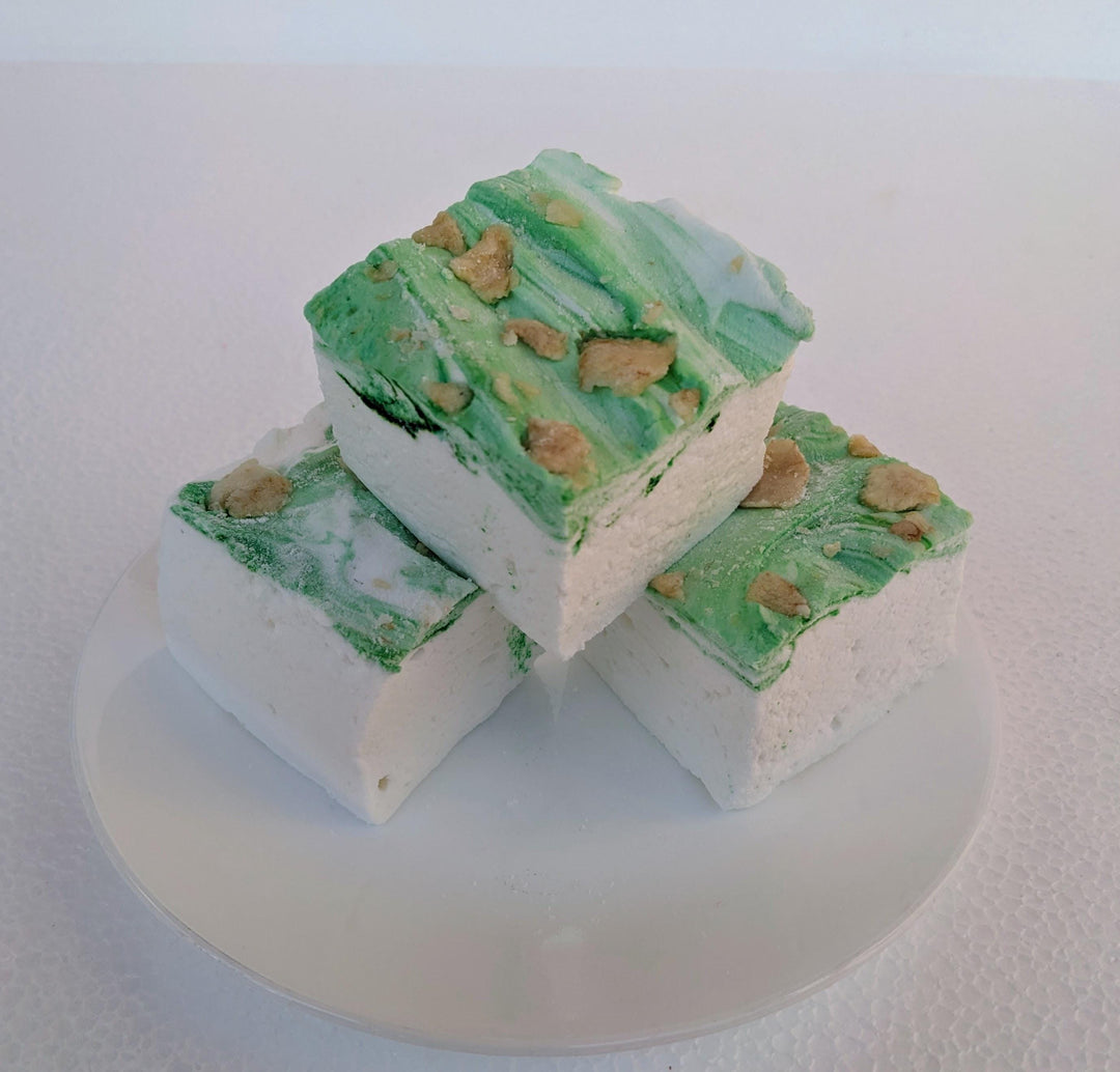 A plate of three handcrafted gourmet pears in wine syrup marshmallows displayed on a clean white background. The marshmallows are approximately 2" x 2" x 1.5" each, arranged on a clean white plate. The text prominently features The Toasty Smore logo and a "Made in USA" flag, emphasizing the artisanal quality and craftsmanship.