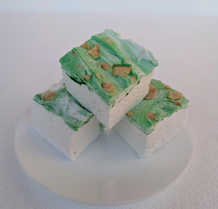 A plate of three handcrafted gourmet pears in wine syrup marshmallows displayed on a clean white background. The marshmallows are approximately 2" x 2" x 1.5" each, arranged on a clean white plate. The text prominently features The Toasty Smore logo and a "Made in USA" flag, emphasizing the artisanal quality and craftsmanship.