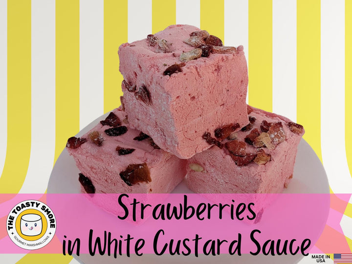 Stack of Three Handcrafted Gourmet Strawberries in White Custard Sauce Marshmallows on a Yellow and White Striped Background with The Toasty Smore Logo and Made in USA Flag