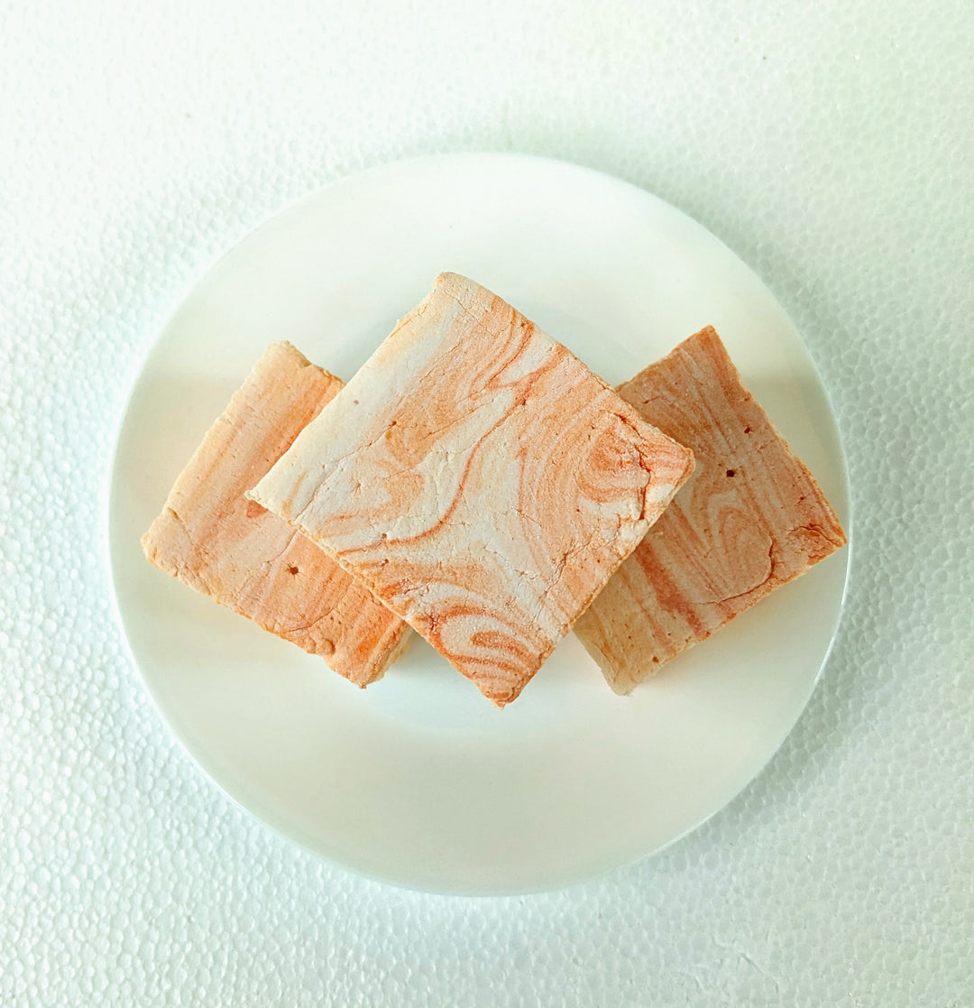 Top-down view of a handcrafted salted caramel gourmet marshmallow, showcasing its rich, golden caramel swirls against a soft, pillowy texture. Elegantly placed on a crisp white plate, this artisan confection embodies indulgence, perfect for luxury dessert lovers seeking a premium sweet experience.