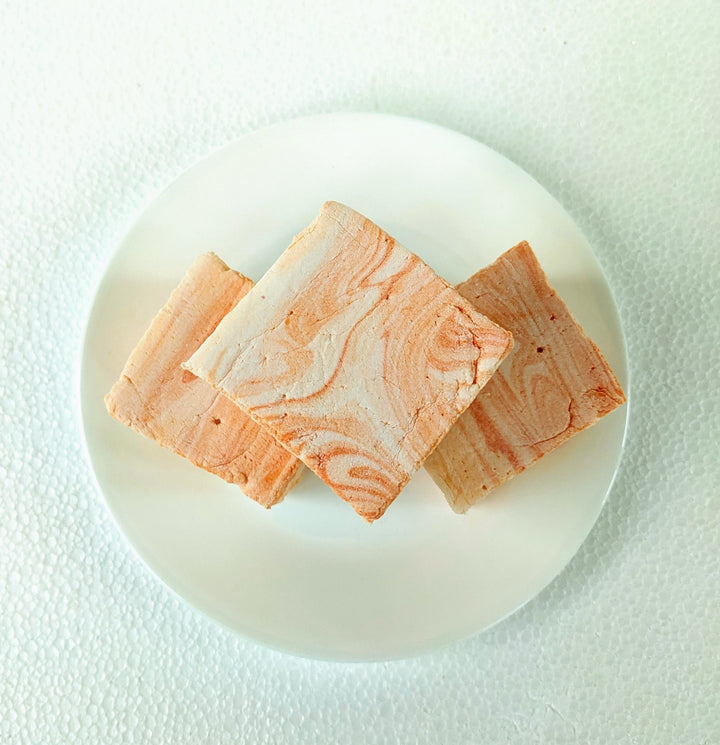 Top-down view of a handcrafted salted caramel gourmet marshmallow, showcasing its rich, golden caramel swirls against a soft, pillowy texture. Elegantly placed on a crisp white plate, this artisan confection embodies indulgence, perfect for luxury dessert lovers seeking a premium sweet experience.