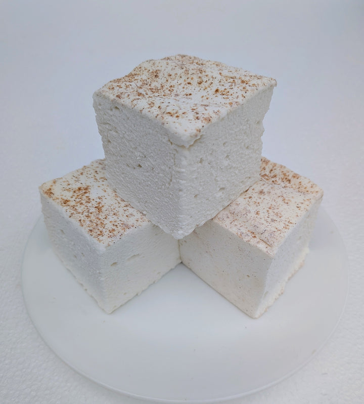 A trio of handmade horchata marshmallows showing natural creamy color and cinnamon dusting, crafted with beef gelatin and organic marshmallow root.