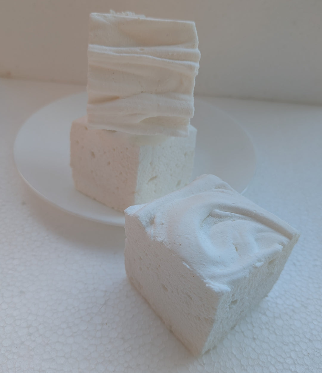 Irish cream gourmet marshmallows on a white plate with a white background