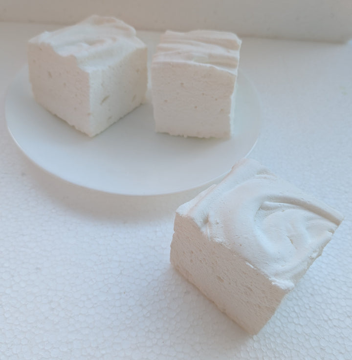 Three blocks of Irish cream gourmet marshmallows on a white surface