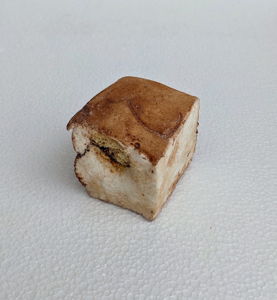 A single handcrafted gourmet tiramisu marshmallow, dusted with rich cocoa powder, showcasing its fluffy texture and espresso-infused layers for a decadent dessert experience.