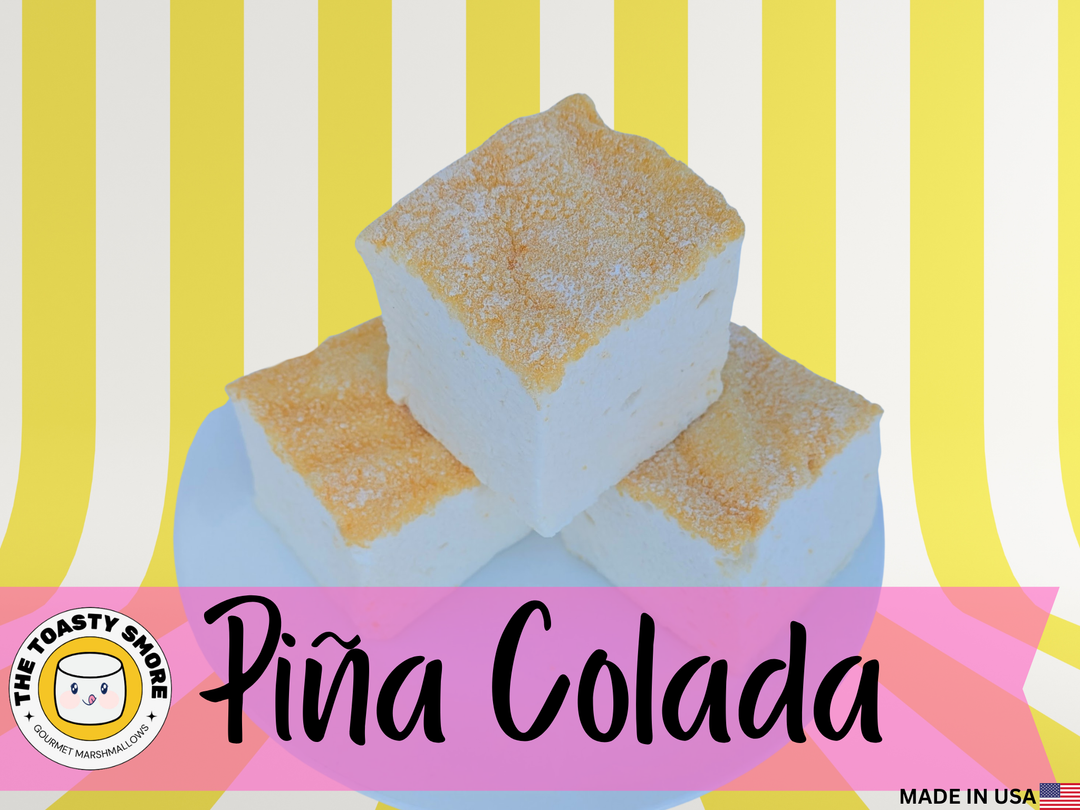Three fluffy Piña Colada marshmallows stacked on a plate, toasted on top and made with beef gelatin and organic marshmallow root; clean‑label, corn‑syrup free real marshmallows.