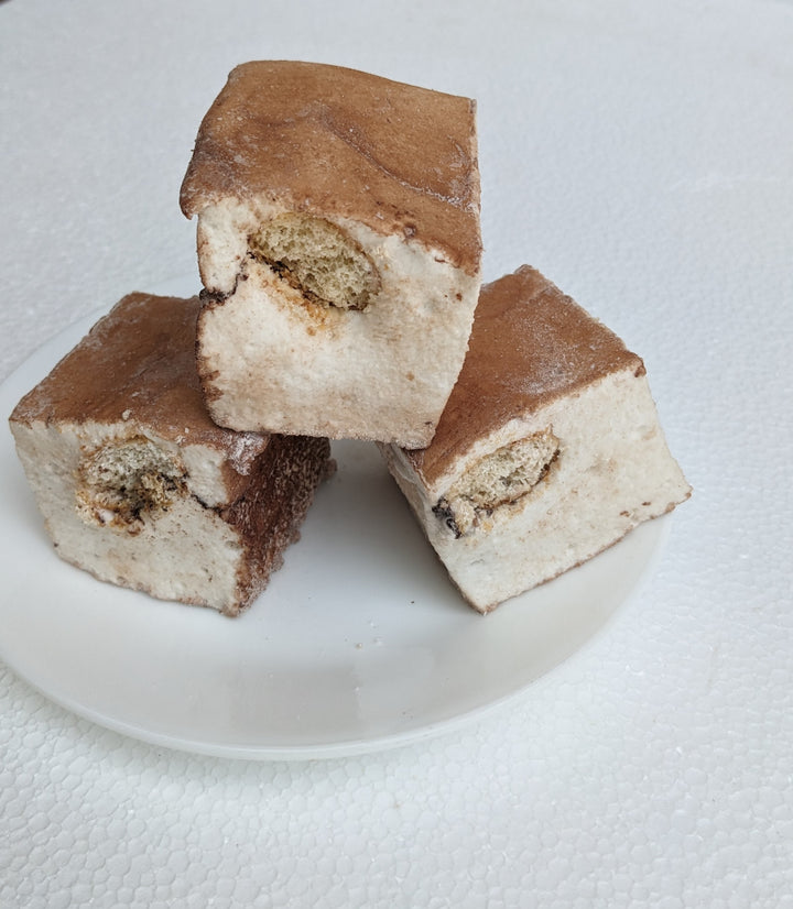 Handcrafted gourmet marshmallows with a decadent tiramisu twist—three pillowy-soft, espresso-infused marshmallows dusted with fine cocoa powder on a plate. These artisan marshmallows offer a luxurious fusion of coffee, mascarpone, and chocolate flavors, making them an irresistible indulgence for dessert lovers. Perfect for specialty gifting, upscale treats, or pairing with hot beverages for a rich, melt-in-your-mouth experience.