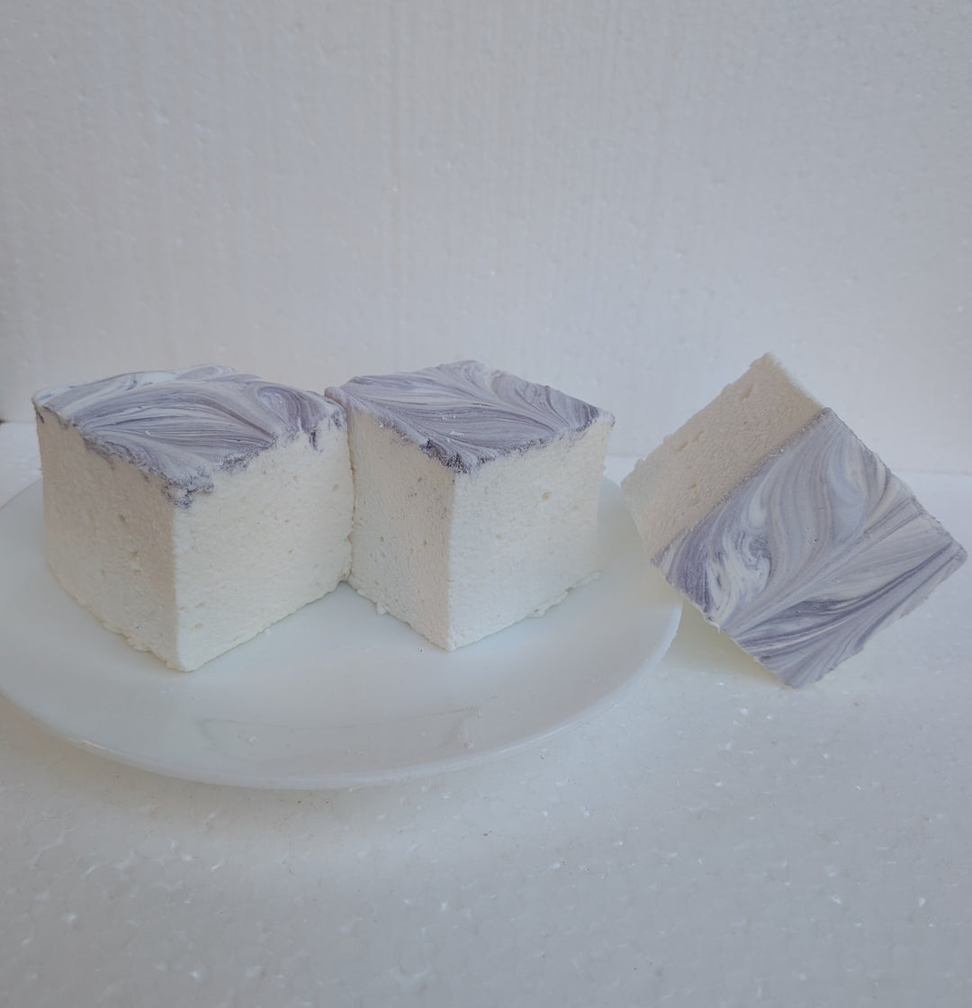 Side view of three Creamy Taro marshmallows with white bases and purple swirled tops, photographed on a bright white background, made in the USA with Halal‑certified beef gelatin, organic marshmallow root, natural dyes, no corn syrup, and gluten‑free ingredients from The Toasty S’more.