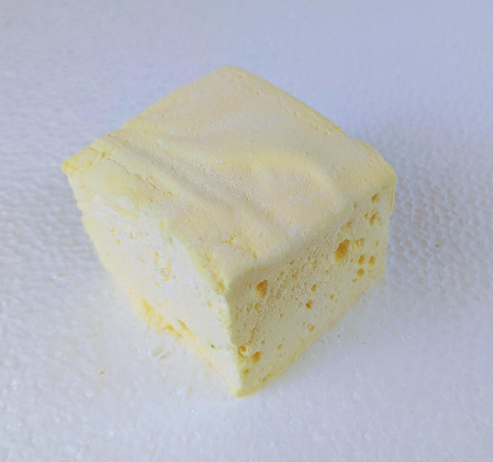 A single extra-large Butter Vanilla gourmet marshmallow made with organic marshmallow root and premium beef gelatin, displayed on a white plate against a plain white background.