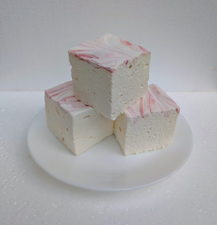 Strawberries and cream real marshmallows with natural pink and white swirls stacked on a white plate, made in the USA with Halal beef gelatin, organic marshmallow root, no corn syrup, and gluten‑free ingredients.
