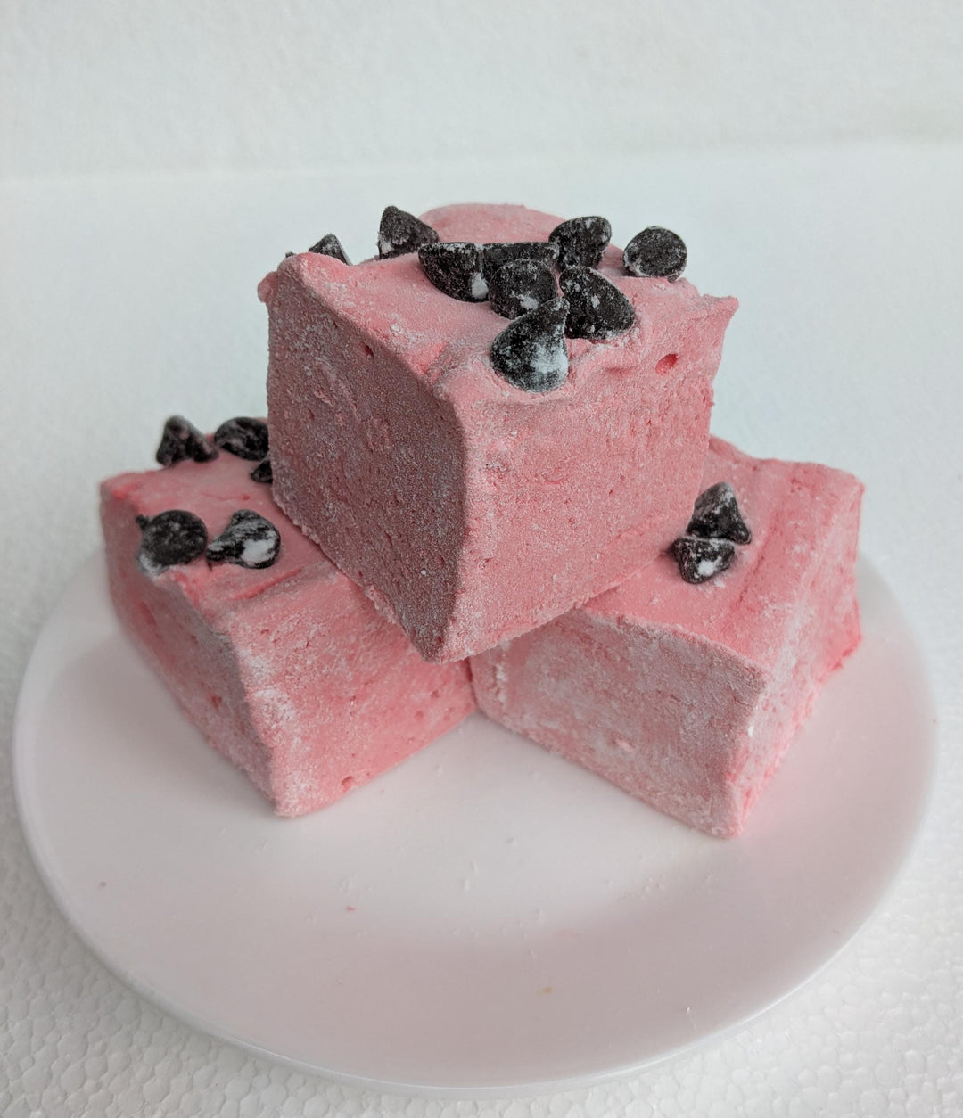 A stack of three Gourmet Handcrafted Wild Cherry Chip Marshmallows on a white plate