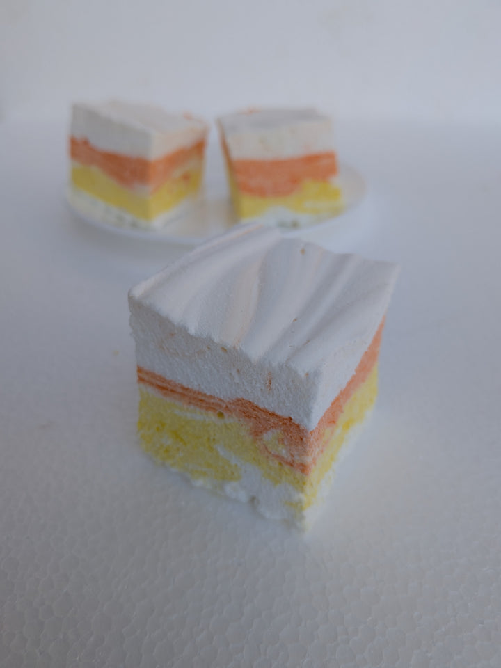 Three layered candy corn gourmet marshmallows made in usa with white, yellow, and orange colors on a white background