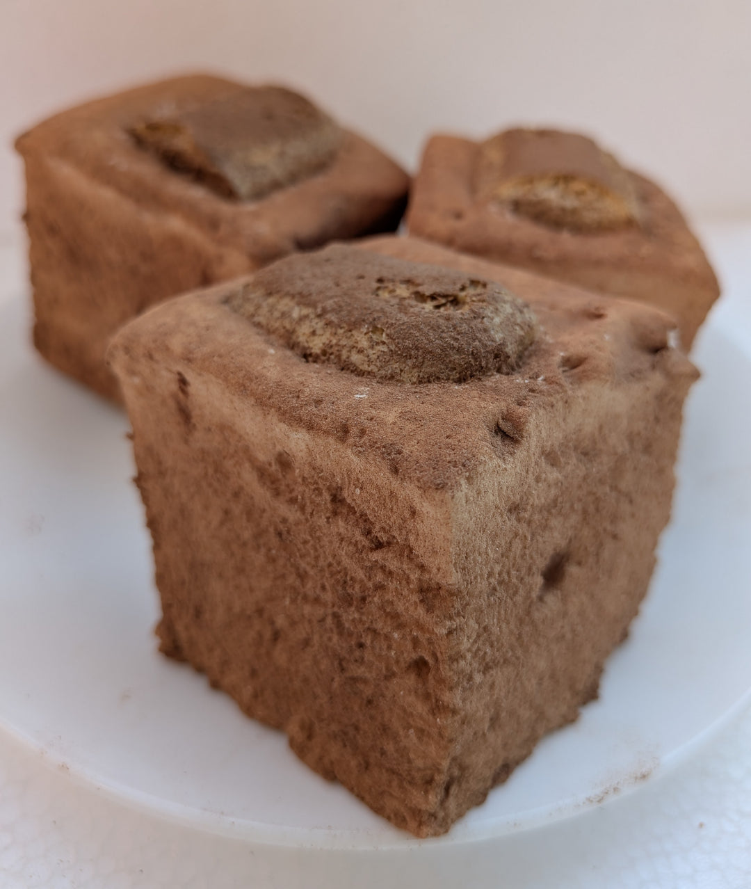 Three Tiramisu Gourmet Marshmallows on a white plate