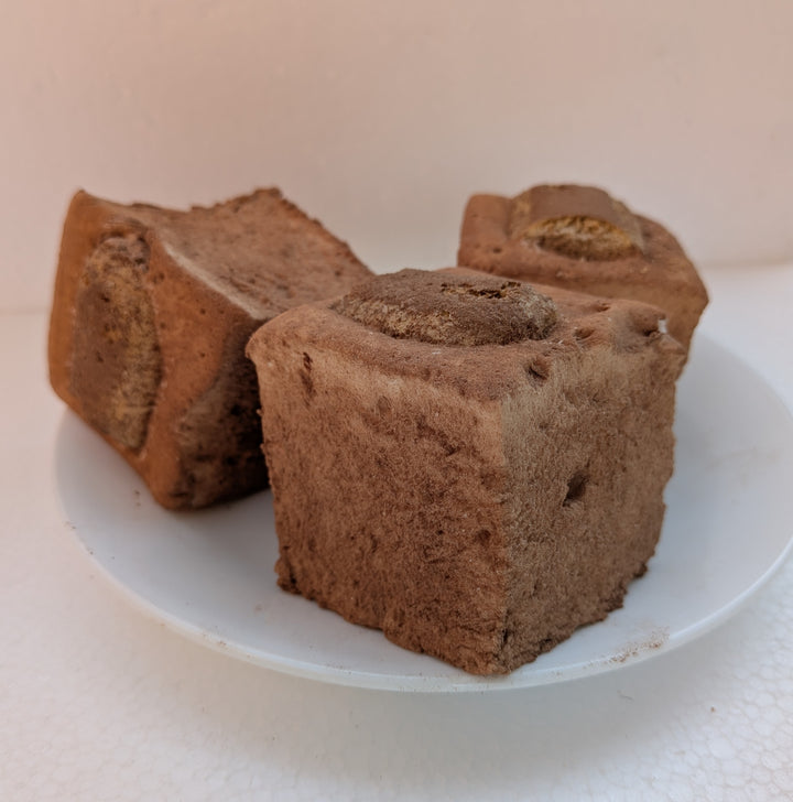 Three pieces of Tiramisu Gourmet Marshmallows on a white plate with a light background