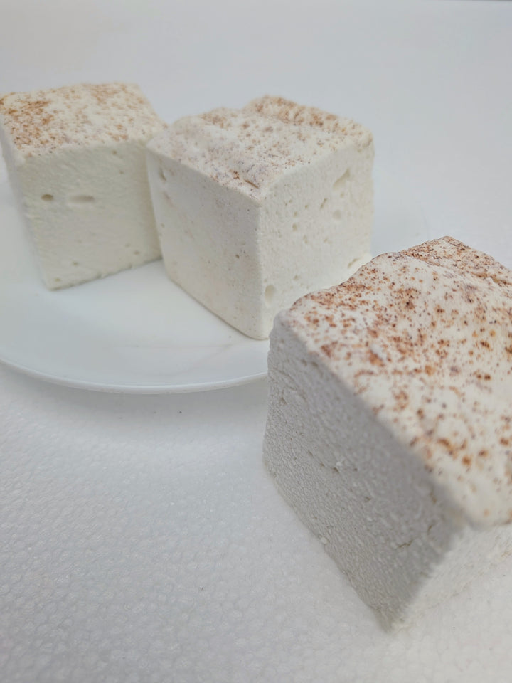 Three handcrafted horchata marshmallows with cinnamon on top and bottom, naturally creamy with no added color, made with organic marshmallow root.