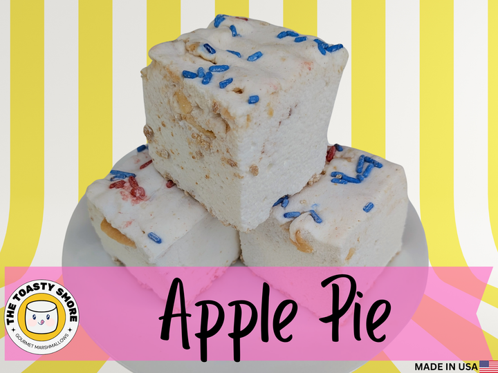 Three marshmallows with blue sprinkles on a white plate against a yellow and pink striped background, branded 'The Toasty Smore'.