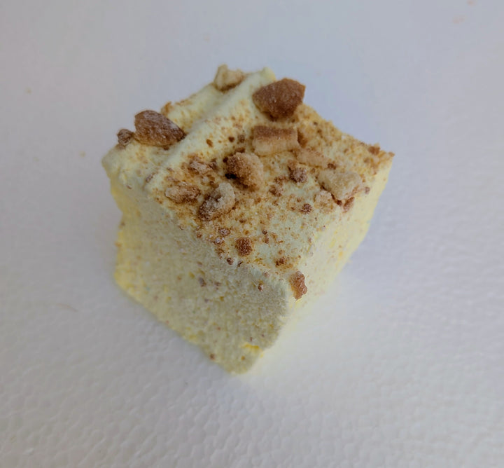 A single Banana Cream Pie gourmet marshmallow made in the USA with organic marshmallow root and premium beef gelatin, topped with crumbly topping on a white background.