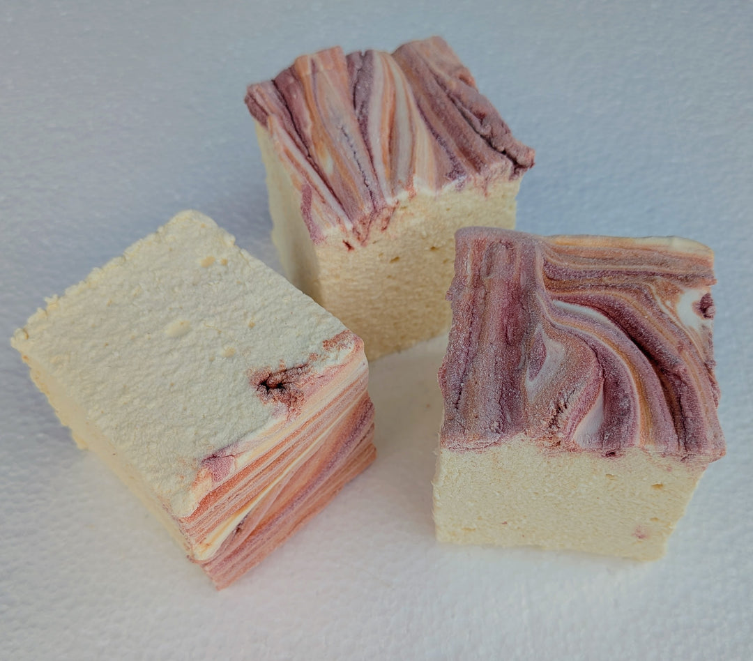 Pale yellow marshmallows featuring hand‑applied red and orange seasonal swirls, crafted in small batches using natural colors, artificial flavors, and gluten‑free corn starch.
