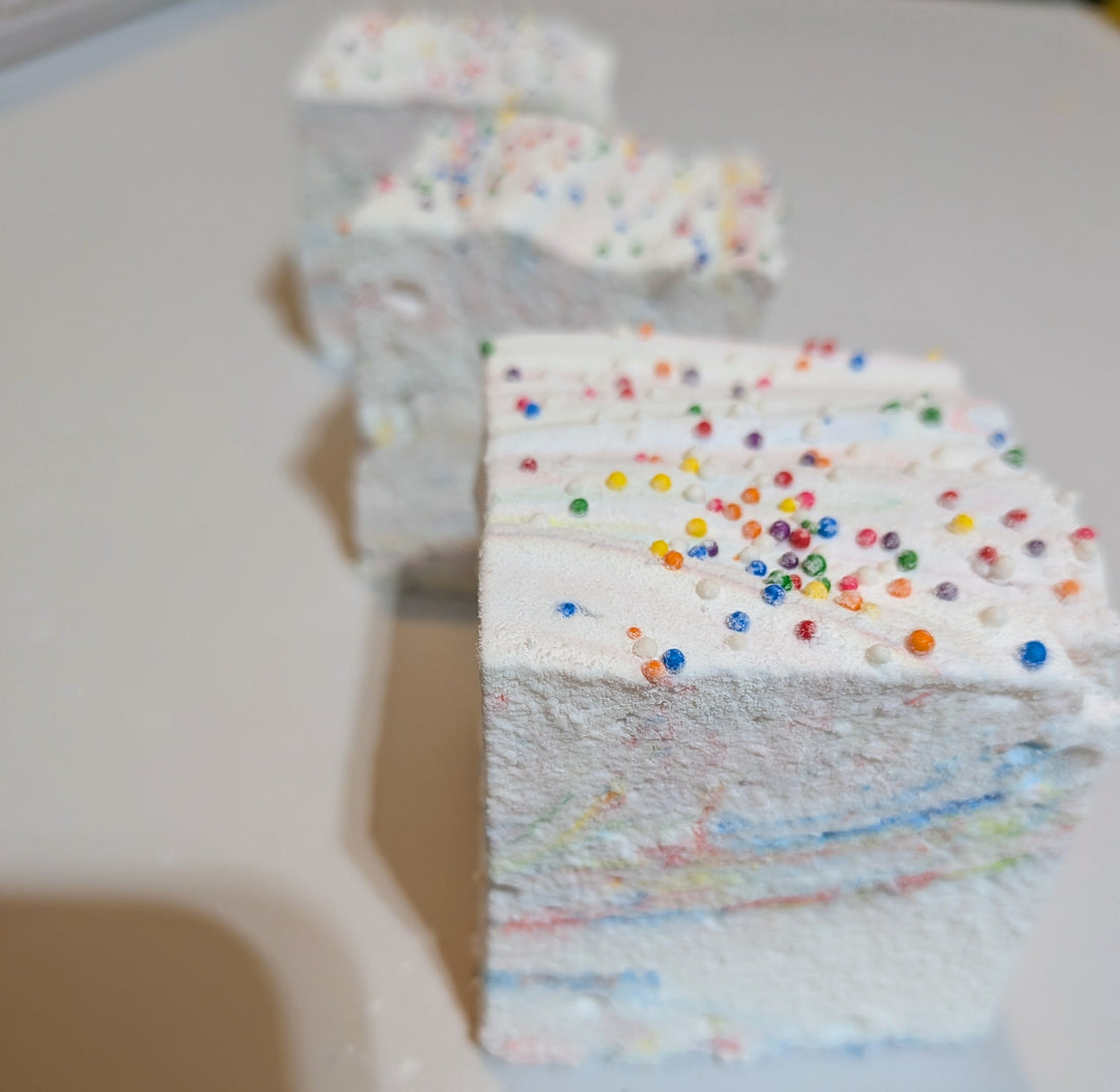 Close-up of a Tutti Frutti gourmet marshmallow topped with rainbow sprinkles, showcasing its soft texture and vibrant fruity layers. Handcrafted by The Toasty S’more with organic marshmallow root, beef gelatin, and no corn syrup, this jumbo 2-inch cube is a colorful, gluten-free treat made in USA.