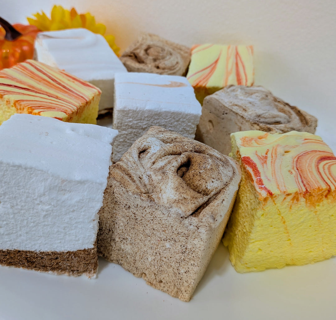 Assorted marshmallow treats with different flavors on a white background