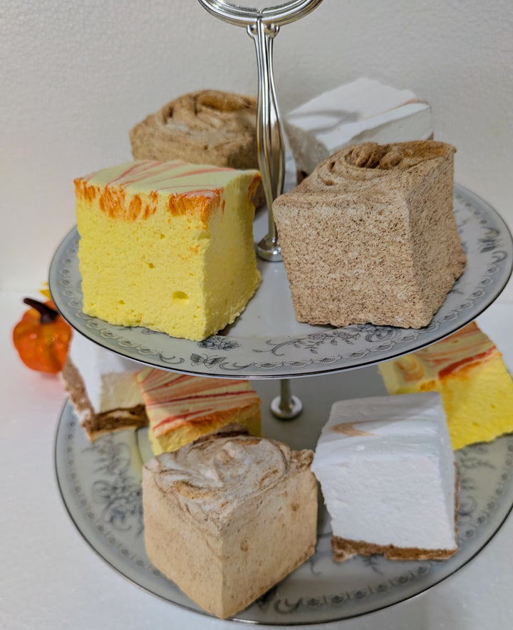 Three-tiered cake stand with fall cravings gourmet marshmallow bundle on a white surface
