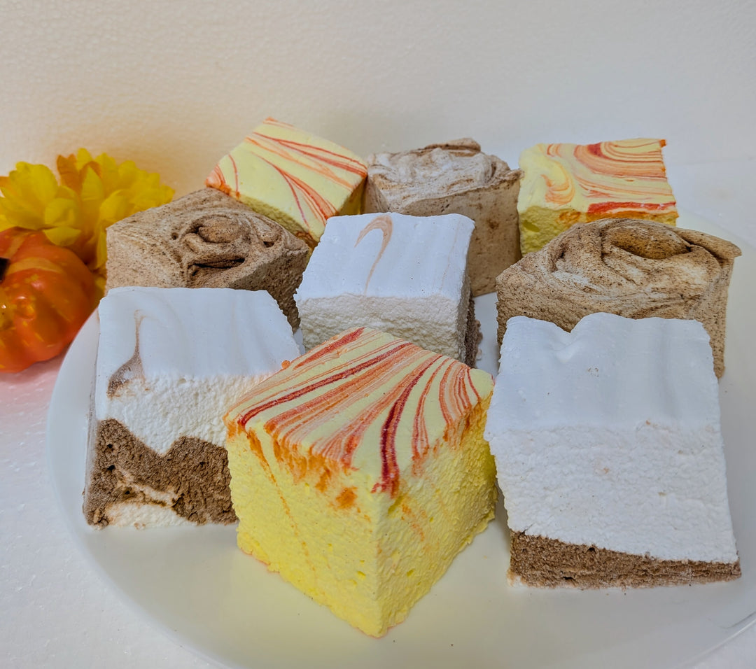 Assorted fall cravings gourmet marshmallow bundle on a white plate with a blurred background