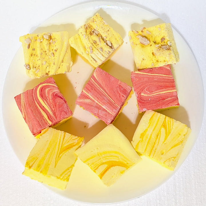 Colorful swirled gourmet marshmallow pieces on a white plate