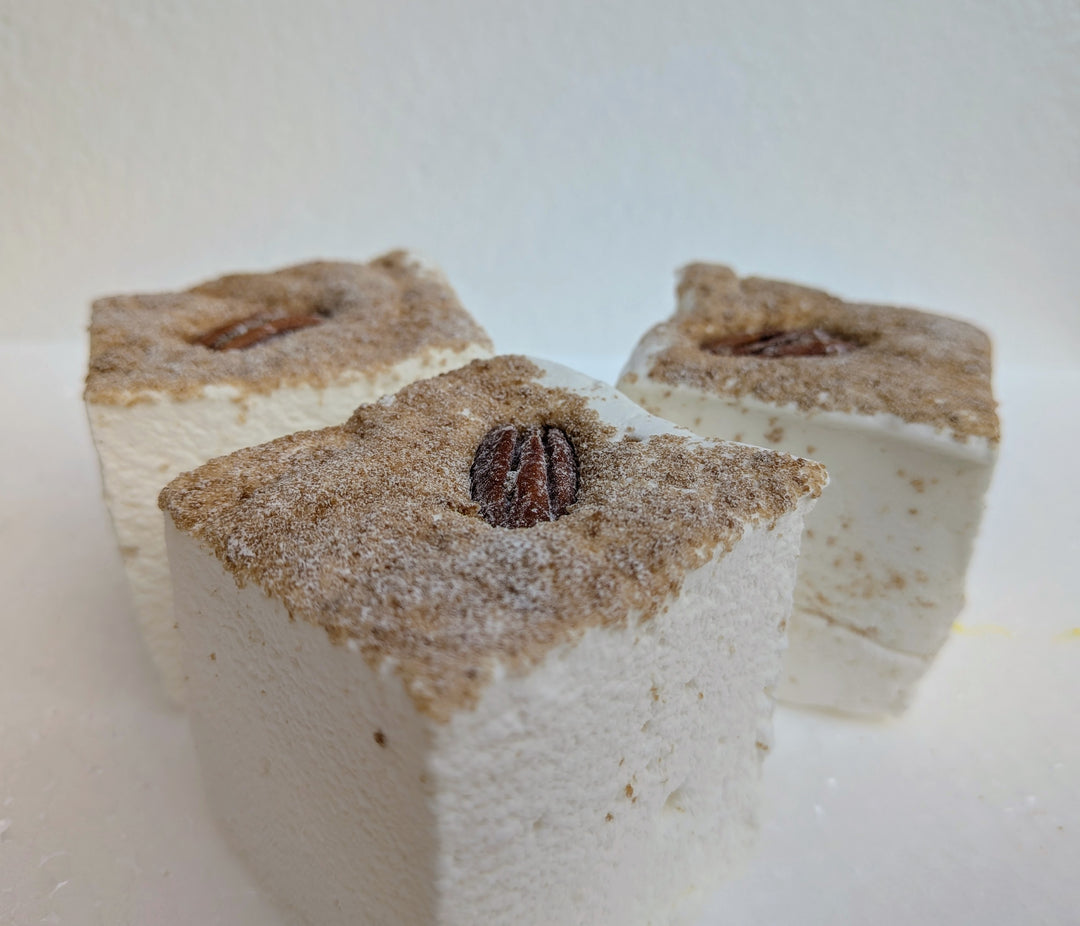 three square maple pecan pie gourmet marshmallows with a pecan on top on a white background