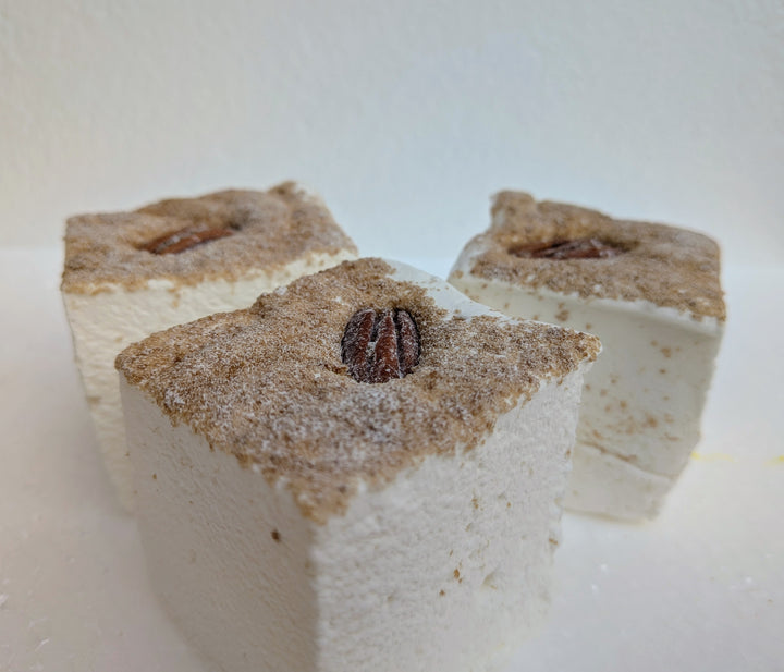 three square maple pecan pie gourmet marshmallows with a pecan on top on a white background