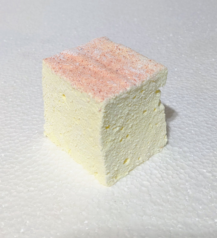 the best gourmet marshmallow in the world Handcrafted pink lemonade marshmallow, gently marbled with pink and yellow, arranged on a white plate for a visually striking, artisan presentation.