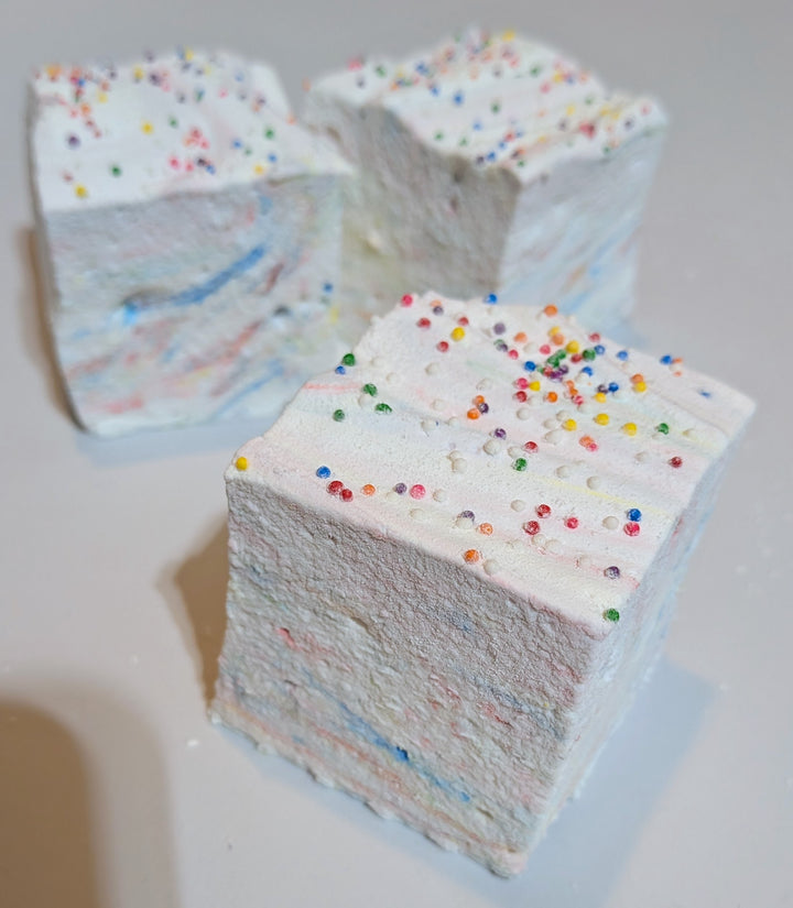 Detailed close-up of a Tutti Frutti gourmet marshmallow with rainbow sprinkles, highlighting its soft texture and handcrafted edges. Made by The Toasty S’more using organic marshmallow root, beef gelatin, and no corn syrup, this jumbo 2-inch cube is a clean-label, gluten-free treat crafted in USA.