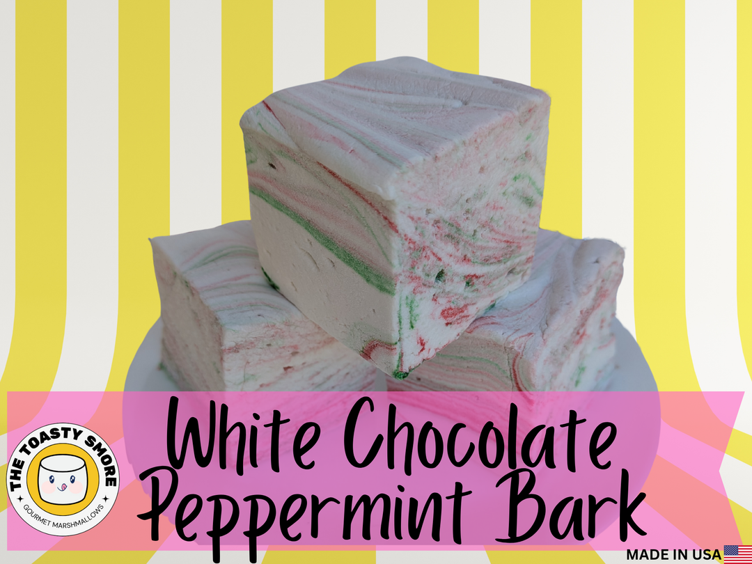 White chocolate peppermint bark with colorful specks on a striped background, featuring 'The Toasty Smore brand.