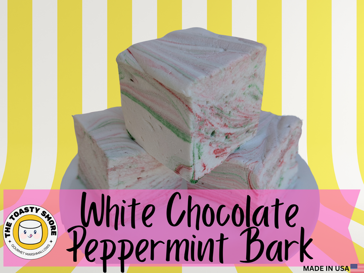 White chocolate peppermint bark with colorful specks on a striped background, featuring 'The Toasty Smore brand.